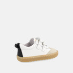 chaussure blanche avec bandes noires, inscription Blanditos sur le côté et semelle épaisse brune.