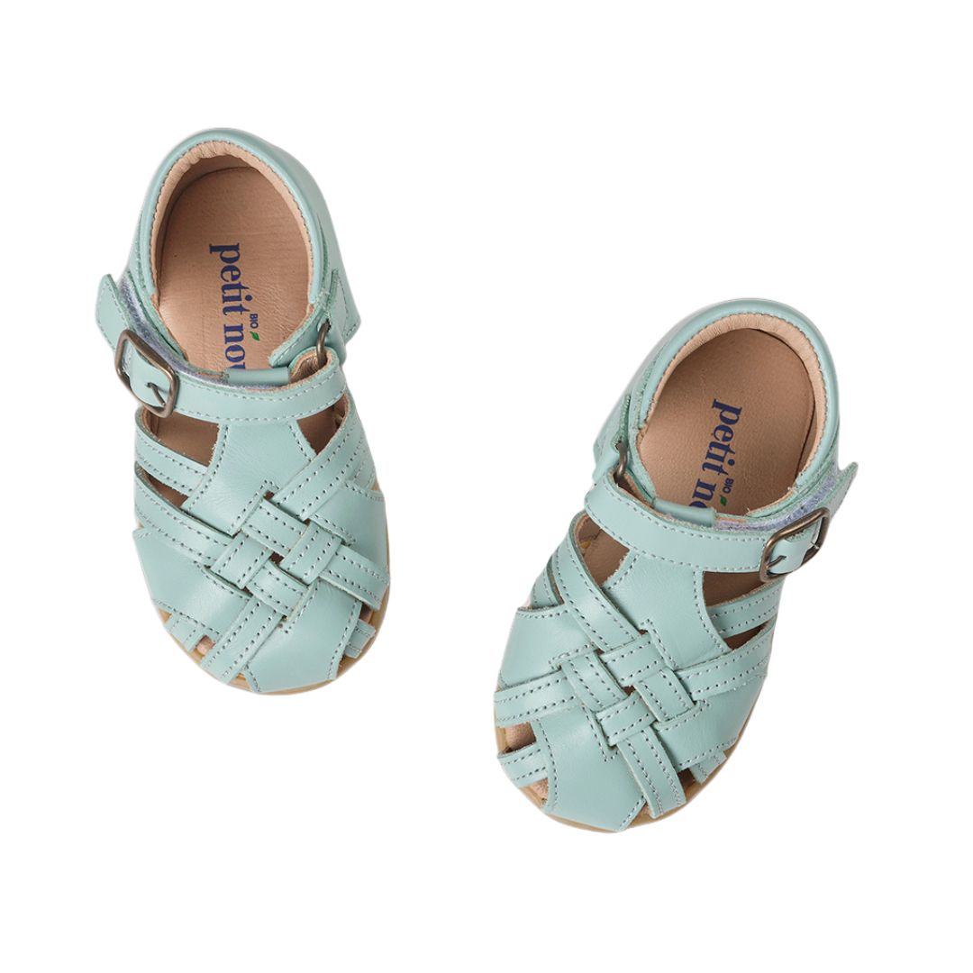 Paire de sandale en cuir, très souple, dans un beau turquoise pastel, à bout fermé et attache velcro.