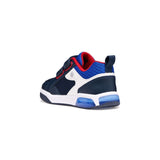 Chaussures pour enfant de couleur marine, blanche et rouge, qui font de la lumière